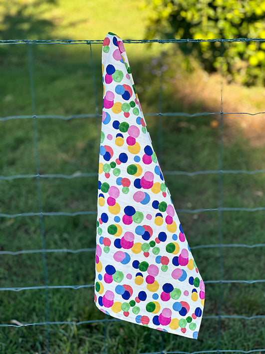 Bec Fing Designs Confetti Tea Towel hanging on fence. Bright colourful spots.